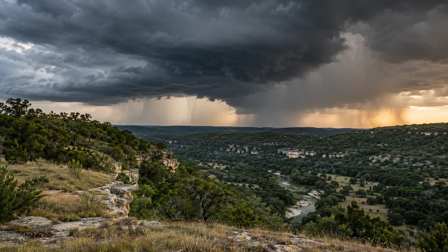 Storm clouds over Hill Country limestone hills and a creek valley in Central Texas Flash Flood Alley